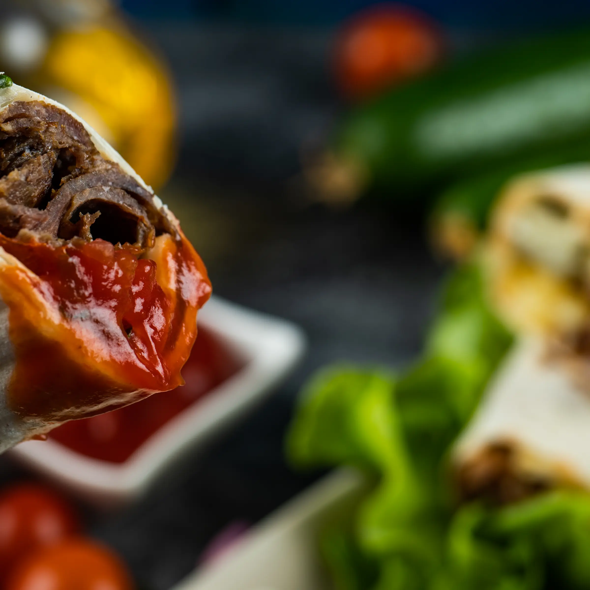 Close up shot of inside of taquito dripping with red hot sauce.